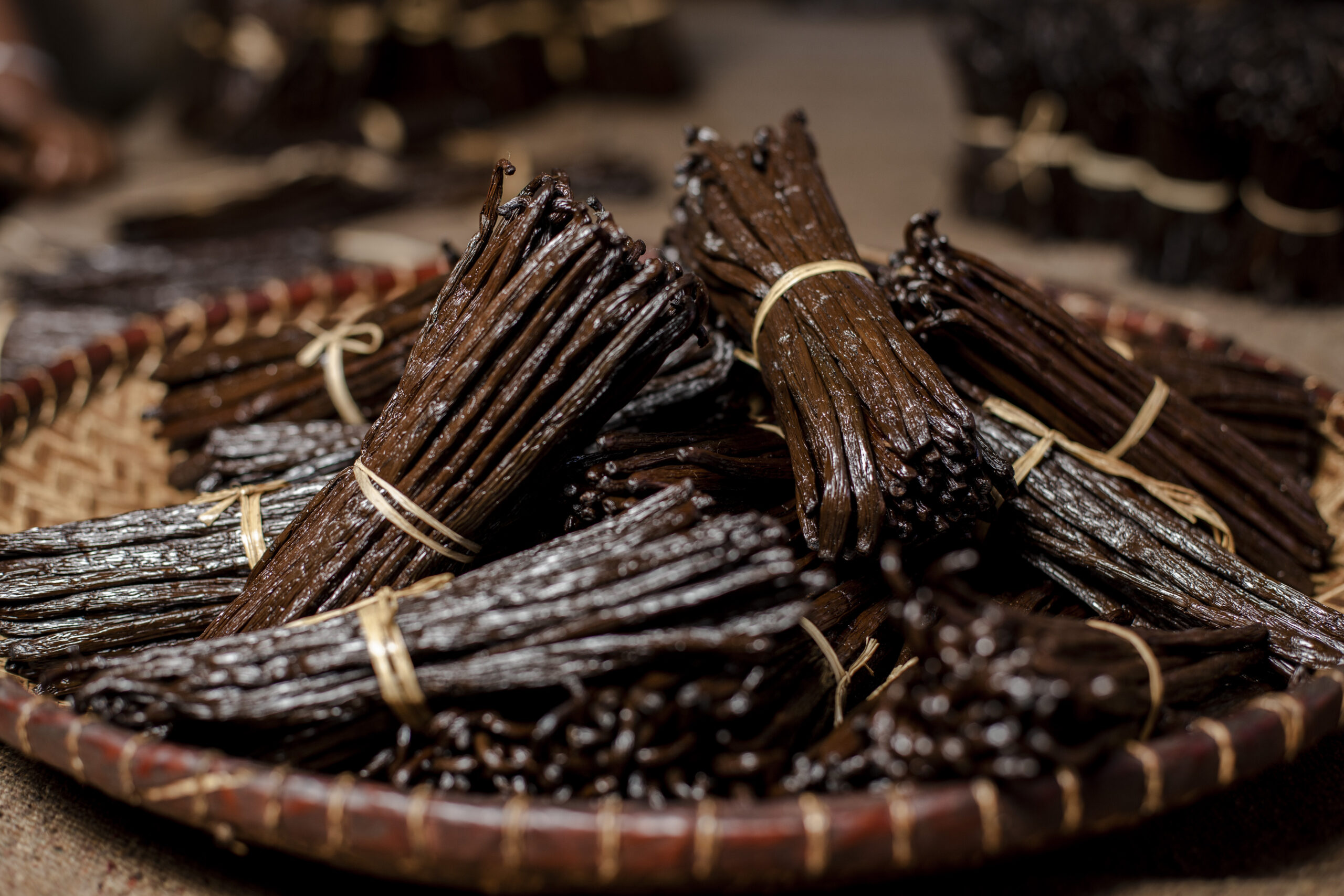 Bundles of cured Madagascar vanilla beans in a basket
